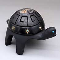 A black turtle figure with a carved shell and sgraffito details with inlaid stones
 by Melony Gutierrez of Santa Clara