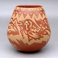 A red jar decorated with an inlaid stone and a sgraffito avanyu and geometric design
 by Sammy Naranjo of Santa Clara