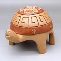 A red and golden micaceous turtle figure with inlaid stones and decorated with a carved and sgraffito hummingbird, butterfly, flower and geometric design
 by Melony Gutierrez of Santa Clara