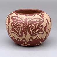 A red bowl decorated with a sgraffito butterfly, hummingbird, kiva step and geometric design
 by Candelaria Suazo of Santa Clara