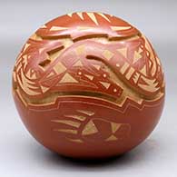 A red and micaceous golden seed pot carved with an avanyu, bear paw and geometric design, click or tap to see a larger version