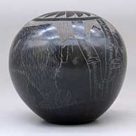 A black and sienna seed pot decorated with a sgraffito bear with two cubs in the mountains and geometric design, click or tap to see a larger version