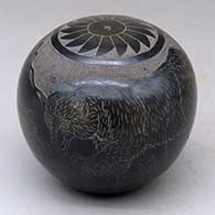 A black and sienna seed pot decorated with a sgraffito bear with two cubs in the mountains and geometric design
 by Melvin Moquino of Santa Clara