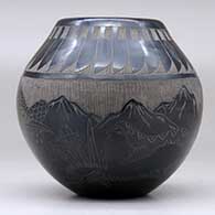 A black jar decorated with a sgraffito feather, roadrunner, serpent and nature design, click or tap to see a larger version