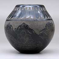 A black jar decorated with a sgraffito feather, roadrunner, serpent and nature design, click or tap to see a larger version