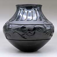A black jar with a flared rim and decorated with a carved avanyu design separated from a carved feather design by a carved band of matte black geometric design, click or tap to see a larger version