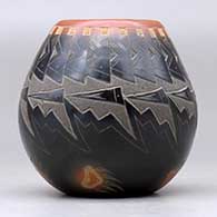 A small black jar with a sienna rim and spots, and decorated with a sgraffito knife-edge, bear paw and geometric design, click or tap to see a larger version