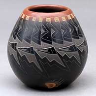 A small black jar with a sienna rim and spots, and decorated with a sgraffito knife-edge, bear paw and geometric design
 by Justin Naranjo of Santa Clara