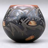 A black jar with a sienna rim and spots, an inlaid stone and a sgraffito avanyu, bear paw and geometric design, click or tap to see a larger version