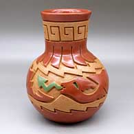 A red, golden micaceous and green tall neck water jar decorated with a carved scroll, feather, avanyu and geometric design
 by Melony Gutierrez of Santa Clara