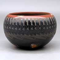 Click for a larger view A black bowl with a sienna rim and spots decorated around the outside with a sgraffito knife edge, bear paw and geometric design
by Justin Naranjo of Santa Clara