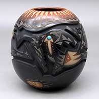 A black jar with a sienna rim and spots deep carved with an avanyu and geometric design with sgraffito designs, bear paws and an inlaid stone
 by Sammy Naranjo of Santa Clara
