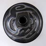 A black flat topped jar carved with an avanyu design above the shoulder
 by Vickie Martinez of Santa Clara