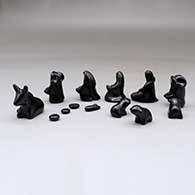 A miniature black on black Dineh-influence 13 piece nativity set, click or tap to see a larger version