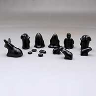 A miniature black on black Dineh-influence 13 piece nativity set, click or tap to see a larger version