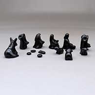 A miniature black on black Dineh-influence 13 piece nativity set, click or tap to see a larger version