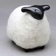 A black sheep figure clothed in a bundle of wool
 by Joe Naranjo of Santa Clara