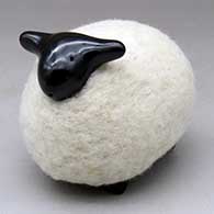 A black sheep figure clothed in a bundle of wool
 by Joe Naranjo of Santa Clara