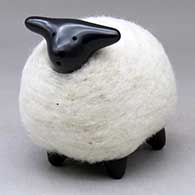 A black sheep figure clothed in a bundle of wool
 by Joe Naranjo of Santa Clara