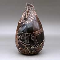 A brown jar with an organic opening, an applique fold and decorated with a sgraffito sea serpent, ocean wave and geometric design, click or tap to see a larger version