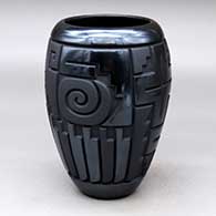 Click for a larger view A matte and polished black cylinder decorated with a four-panel carved spiral, yei, feather and geometric design
by Harrison Begay Jr of Santa Clara