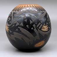 A black jar with a sienna rim and spots, decorated with a sgraffito avanyu, feather, bear paw and geometric design with an inlaid stone, click or tap to see a larger version