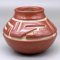 Click for a larger view A red jar decorated with a two panel geometric design carved above the shoulder
by Margaret Tafoya of Santa Clara