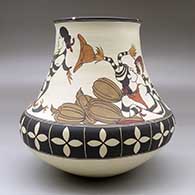 A classic polychrome Tewa jar decorated with a koshare, melon and geometric design, click or tap to see a larger version