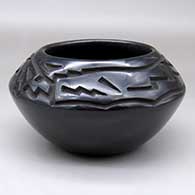 A black bowl carved above the shoulder with an avanyu and geometric design
 by Chris Martinez of Santa Clara