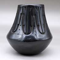 A tall neck black jar decorated with a carved kiva step and geometric design around the neck, click or tap to see a larger version