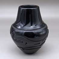 Click for a larger view A black jar carved with an avanyu and band of feathers design
 by Sherry Tafoya of Santa Clara