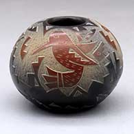 A black jar decorated with sienna spots and a sgraffito hummingbird, butterfly and geometric design
 by Candelaria Suazo of Santa Clara