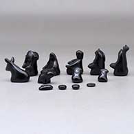 A thirteen piece miniature matte and polished black Nativity scene with Navajo wise men, click or tap to see a larger version
