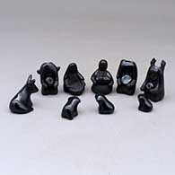 A thirteen piece miniature matte and polished black Nativity scene with Navajo wise men
 by Linda Askan of Santa Clara