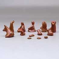 A thirteen piece miniature white on red Nativity scene with Navajo wise men, click or tap to see a larger version