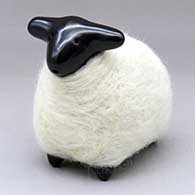 A highly polished black sheep figure in a coat of white wool
 by Joe and Eunice Naranjo of Santa Clara