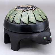 A polychrome turtle figure with sienna spots and decorated with a carved and sgraffito feather, flower, hummingbird and geometric design, plus three inlaid stones
 by Melony Gutierrez of Santa Clara
