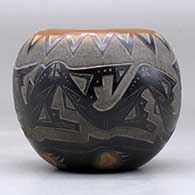 A small black bowl with a sienna rim and spots and decorated with a sgraffito avanyu, bear paw and geometric design, click or tap to see a larger version