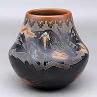 A black jar with a sienna rim and spots, decorated with a sgraffito avanyu, kiva step, bear paw and geometric design plus an inlaid stone
 by Sammy Naranjo of Santa Clara