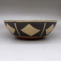 Large polychrome dough bowl with a Mimbres goat design on inside and a geometric design on outside, click or tap to see a larger version