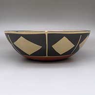 Large polychrome dough bowl with a Mimbres goat design on inside and a geometric design on outside, click or tap to see a larger version