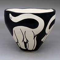 A black-on-white bowl with an organic rim and decorated with an a sauropod design
 by William Pacheco of Santo Domingo