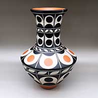 A tall polychrome jar decorated with an eight-panel geometric design
 by Thomas Tenorio of Santo Domingo