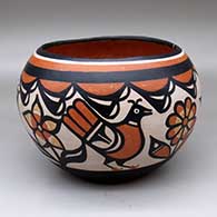 A polychrome bowl decorated inside with a Zia sun sign and outside with a four-panel bird, flower and geometric design
 by Robert Tenorio of Santo Domingo