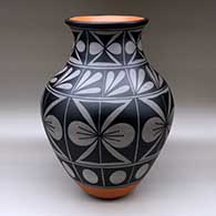 A large polychrome jar with a recurved neck and decorated with a butterfly and geometric design
 by Thomas Tenorio of Santo Domingo