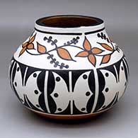 A polychrome jar decorated with a butterfly, vine, leaf, berry and geometric design
 by Vicky Calabaza of Santo Domingo