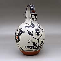 A polychrome wedding vase decorated with a four-panel bird, flower and geometric design, click or tap to see a larger version