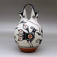 A polychrome wedding vase decorated with a four-panel bird, flower and geometric design, click or tap to see a larger version