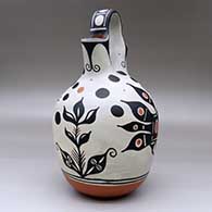 A polychrome wedding vase decorated with a four-panel bird, flower and geometric design, click or tap to see a larger version