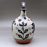 A polychrome wedding vase decorated with a four-panel bird, flower and geometric design, click or tap to see a larger version